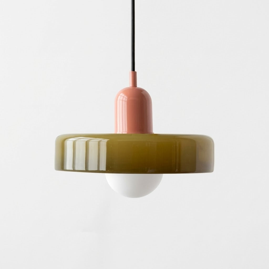 Pendant light with a pink fixture and green base on a white background