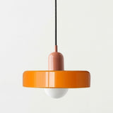 A modern pendant light with a glossy orange circular shade, a dusty rose cylindrical neck, a black hanging cord, and a white globe bulb below, shown against a plain off-white background.