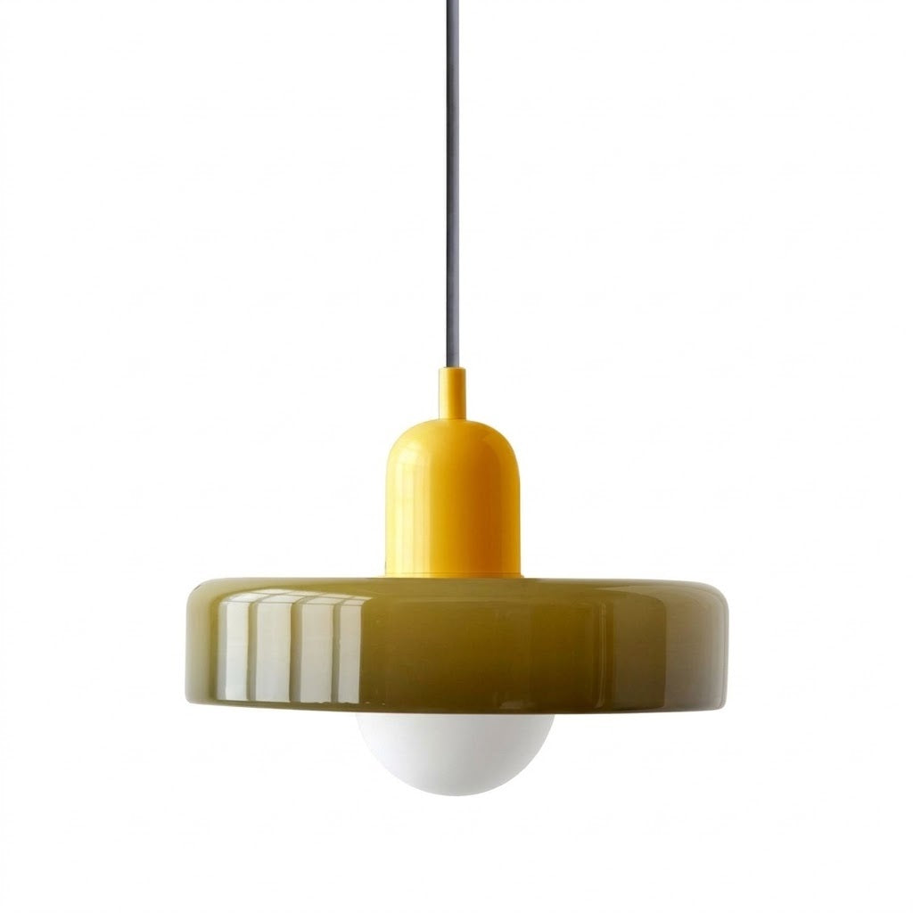 A modern pendant light with a glossy olive green circular shade, a bright yellow central neck, a black hanging cord, and a white globe bulb below, shown against a plain white background.