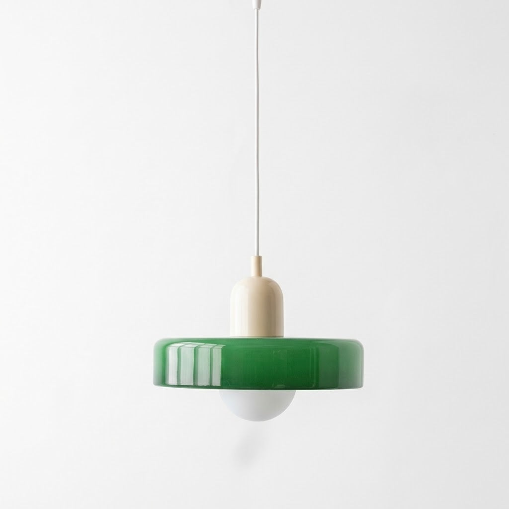 Pendant light with a green glass shade, cream holder, and exposed white bulb hangs against a plain light background.