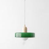 Pendant light with a green glass shade, cream holder, and exposed white bulb hangs against a plain light background.