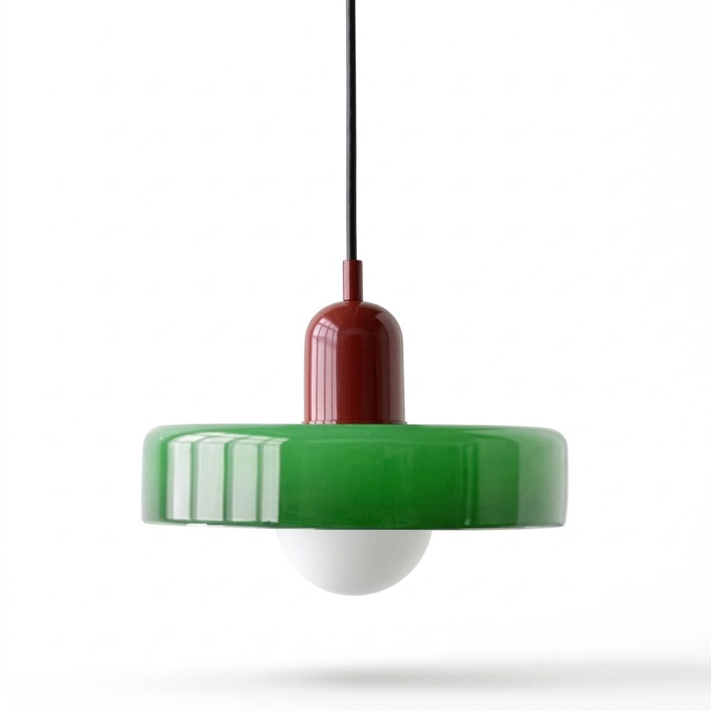 A modern pendant light with a glossy green circular shade, a dark red central cap, a white globe bulb, and a black hanging cord, shown against a plain white background.