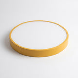 Round ceiling light with a mustard yellow rim and white diffuser, shown at an angle against a white background.