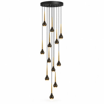 A modern multi-light chandelier with a circular black ceiling canopy, featuring multiple slender black cords suspending teardrop-shaped bulbs with a brushed gold finish, set against a plain white background.