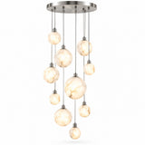 A modern multi-light chandelier with a brushed nickel circular canopy and multiple hanging spherical glass shades with a warm cream and beige marble pattern, shown against a plain white background.