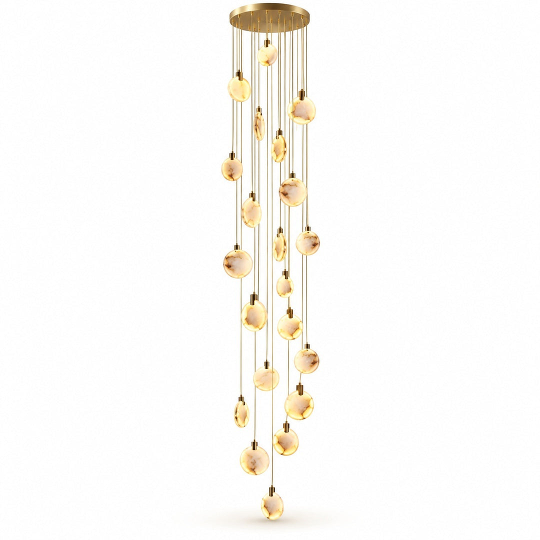 A modern multi-light linear chandelier with a brushed gold finish, featuring multiple clear glass spherical beads that glow with a warm yellow light, suspended from a circular gold ceiling canopy against a solid white background.