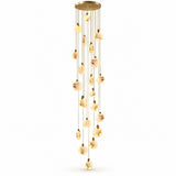 A modern multi-light linear chandelier with a brushed gold finish, featuring multiple clear glass spherical beads that glow with a warm yellow light, suspended from a circular gold ceiling canopy against a solid white background.