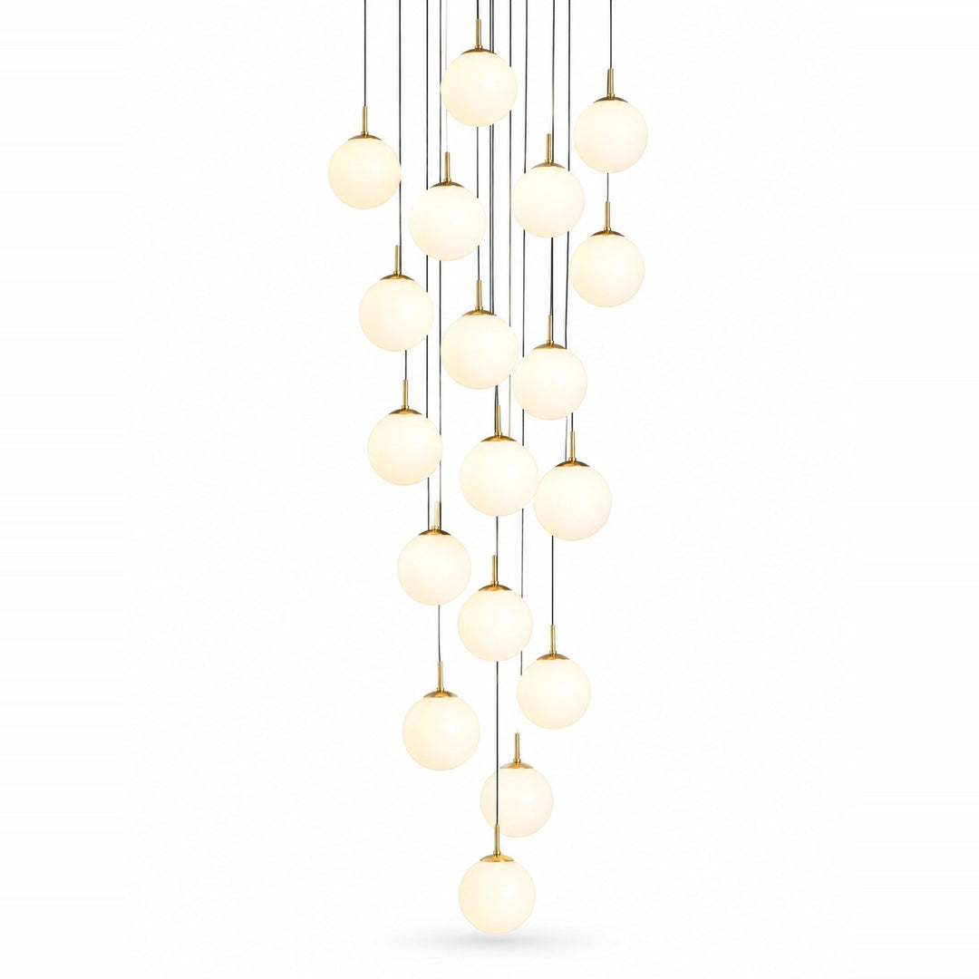 A modern multi-light chandelier featuring multiple spherical frosted glass globes suspended from thin black cords with gold-toned hardware, set against a solid white background.