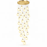 A modern multi-light chandelier with a circular gold ceiling canopy and multiple cascading strands of glowing warm white spherical glass bulbs, shown against a plain white background.