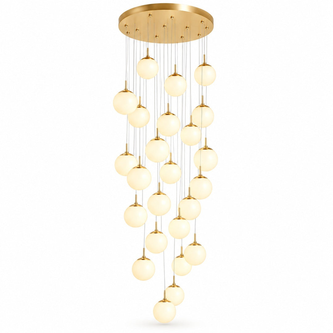 Gold chandelier with a round ceiling canopy and cascading illuminated glass globes suspended at varying heights against a white background.