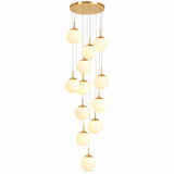 A modern multi-light linear chandelier with a gold-toned circular ceiling canopy, slim suspension rods, and multiple warm white spherical glass shades of varying sizes.
