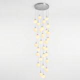 A modern multi-light linear chandelier with a circular silver ceiling canopy and multiple vertical strands of glowing warm white spherical bulbs, shown against a plain white background.