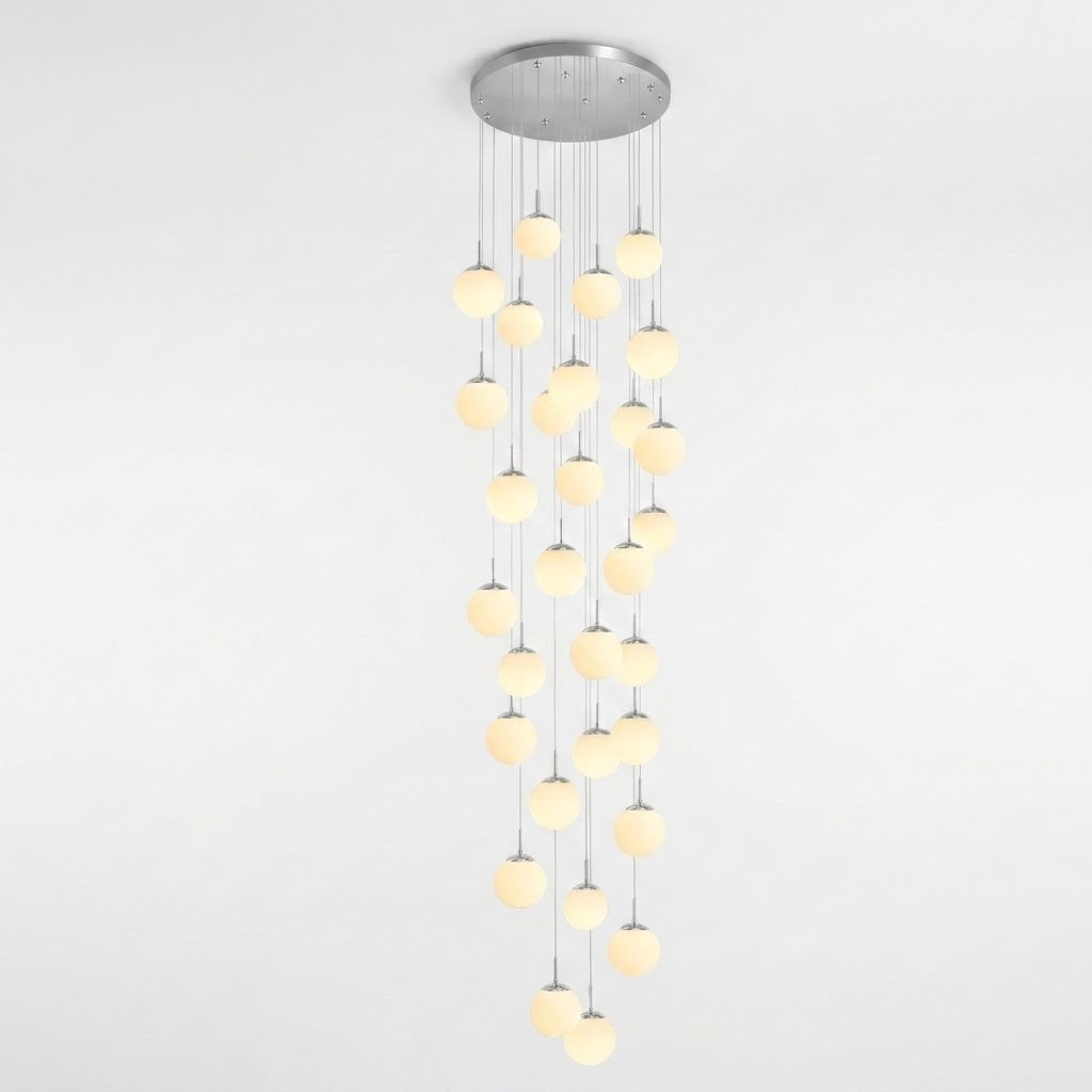 A modern multi-light linear chandelier with a circular silver ceiling canopy and multiple vertical strands of glowing warm white spherical bulbs, shown against a plain white background.