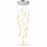A modern multi-light chandelier pendant fixture with a circular silver ceiling canopy and multiple hanging glass globes emitting a warm yellow glow, shown against a plain white background.