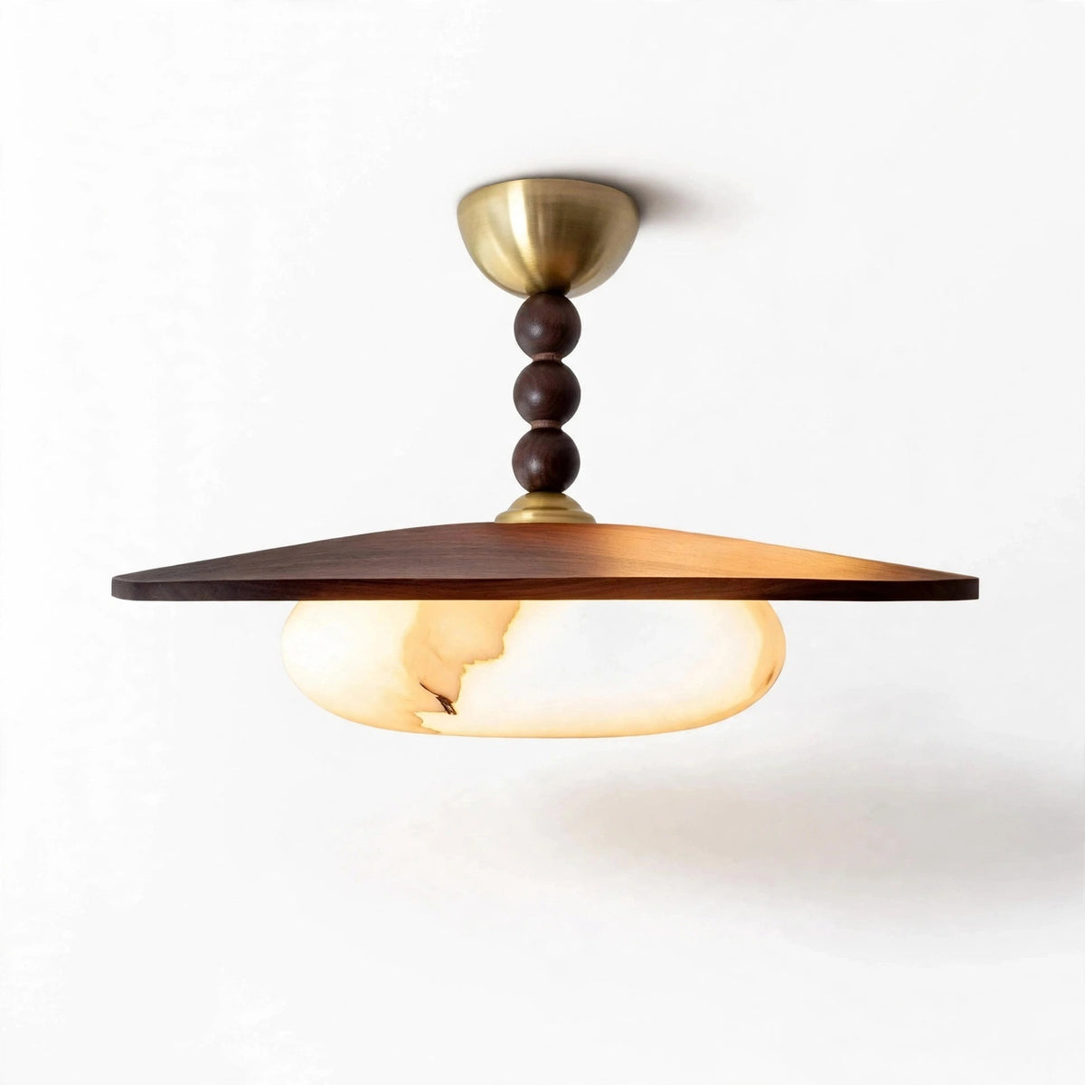 Pendant light with a wide brown wooden shade, glowing marble-effect glass, dark rounded stem details, and gold-toned canopy against a white background.
