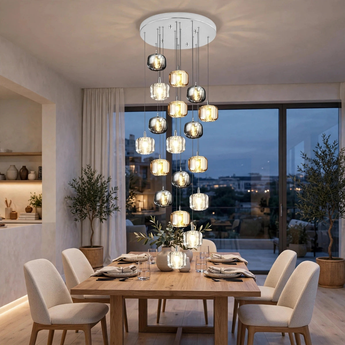 A modern multi-light chandelier with hanging glass globes and clear cylindrical shades, suspended over a wooden dining table in a contemporary dining room at dusk.