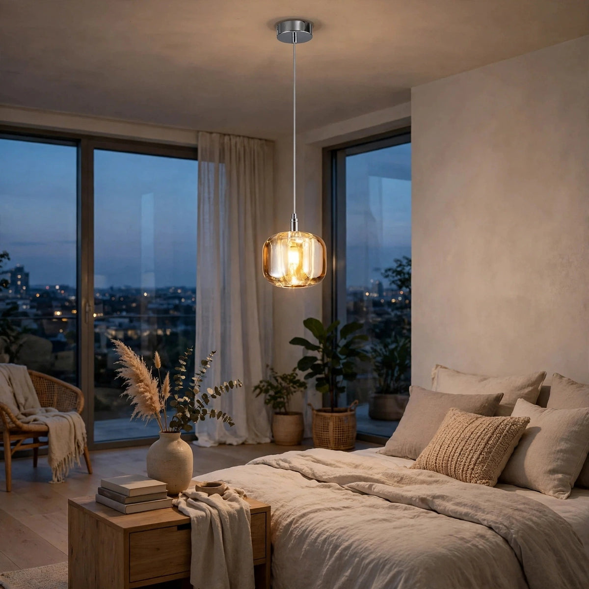 An amber crystal chandelier glows beside a beige bed in a bedroom with tall windows and light curtains.