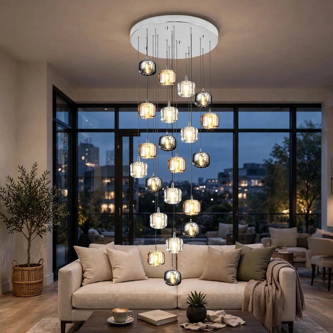 A modern multi-light chandelier with multiple glass globe shades of varying sizes hanging from a circular white ceiling mount in a contemporary living room.