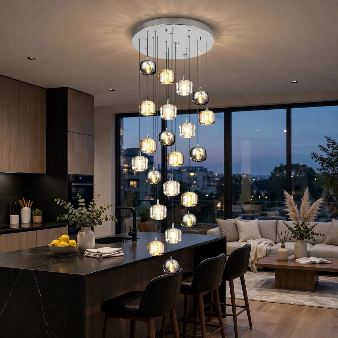 A modern multi-light chandelier with clear glass cylindrical pendant bulbs hanging from a white circular ceiling canopy in a contemporary kitchen and living room setting.