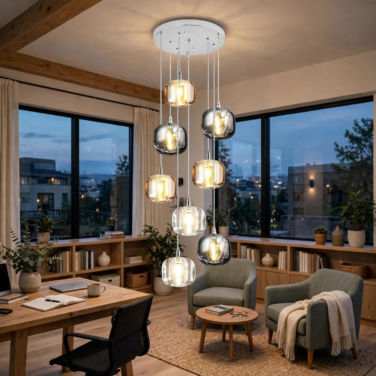 A modern multi-light pendant chandelier with nine glass globe shades in silver and smoked finishes, illuminated with a warm glow, hanging in a contemporary office or lounge room with large windows and wooden accents.