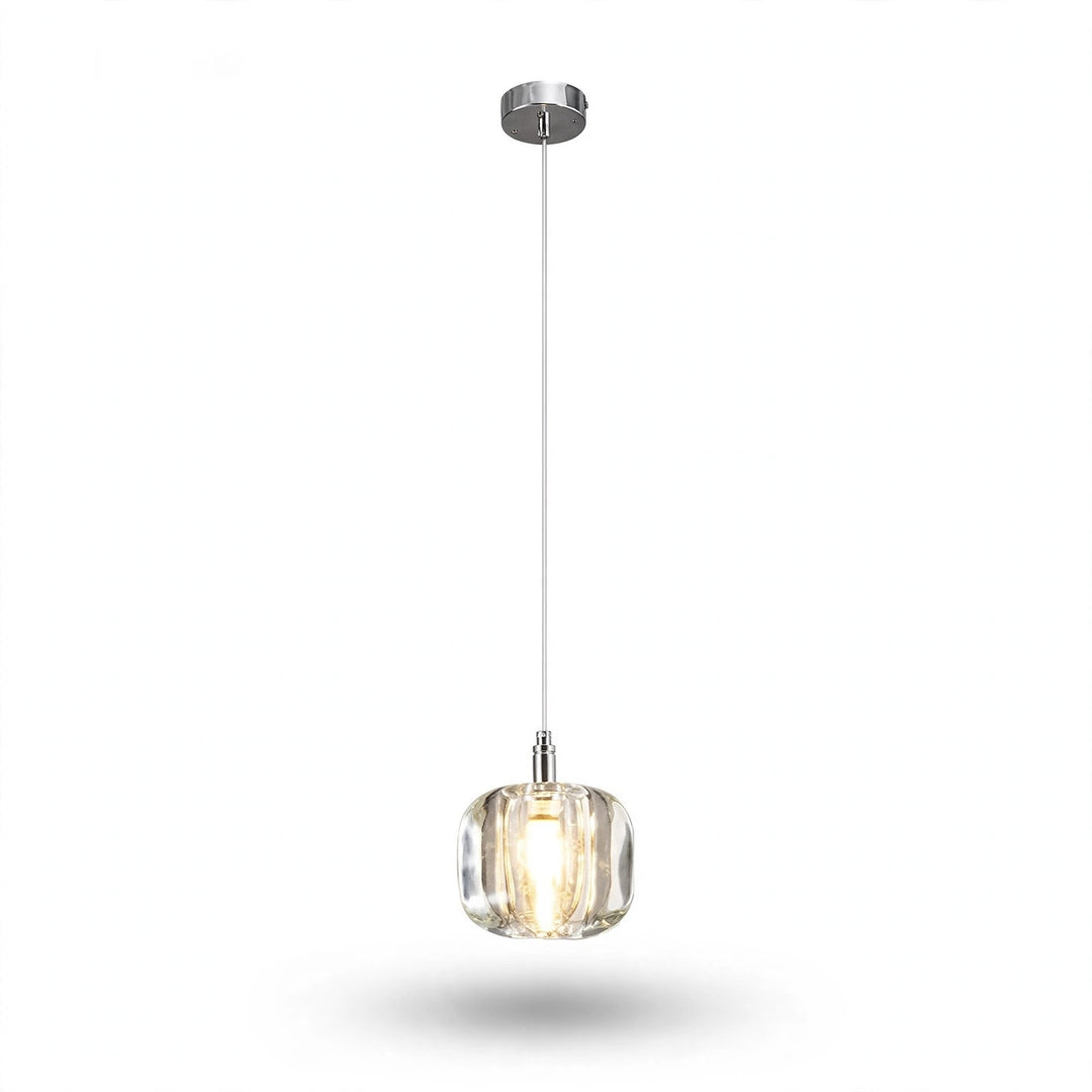 A single-light chandelier with a clear rounded crystal shade and polished silver canopy glows warmly against a white background.