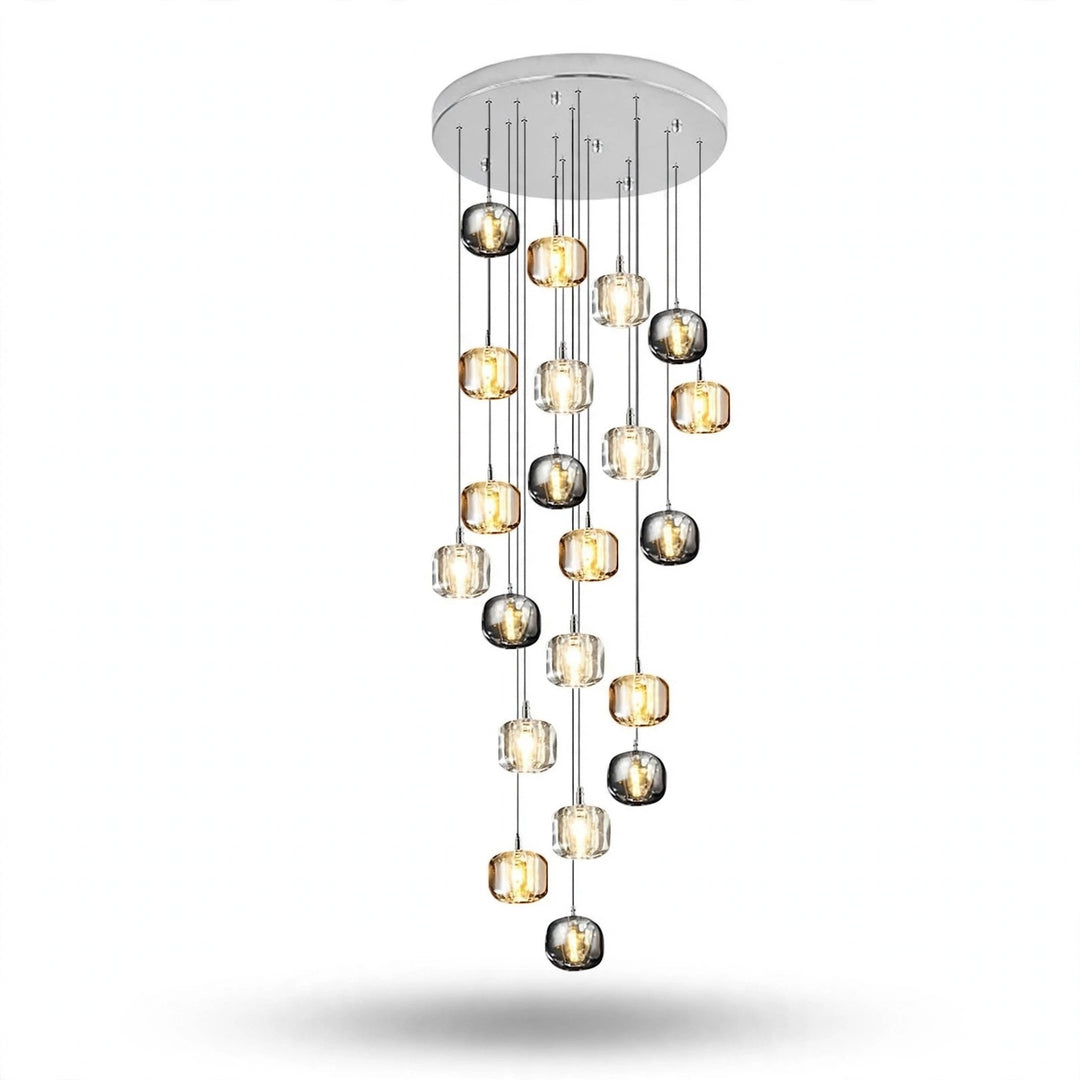 A modern multi-light chandelier with a circular silver ceiling canopy, featuring multiple glass globes in clear, smoked, and metallic finishes suspended at varying lengths against a white background.