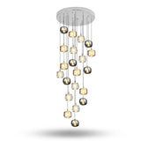 A modern multi-light chandelier with a circular silver ceiling canopy, featuring multiple glass globes in clear, smoked, and metallic finishes suspended at varying lengths against a white background.