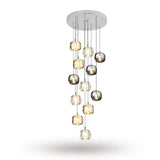 A twelve-light chandelier cascades from a round silver canopy, with clear, amber, and smoky grey crystal shades against a white background.