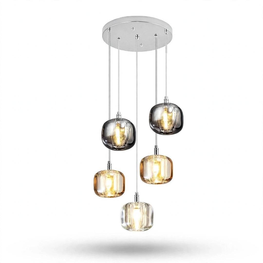 A chandelier has five illuminated smoky grey, amber, and clear shades cascading beneath a round silver canopy against a white background.