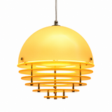 A modern pendant light with a large, dome-shaped frosted yellow shade and multiple concentric horizontal rings below, suspended by a thin metal cord against a plain white background.