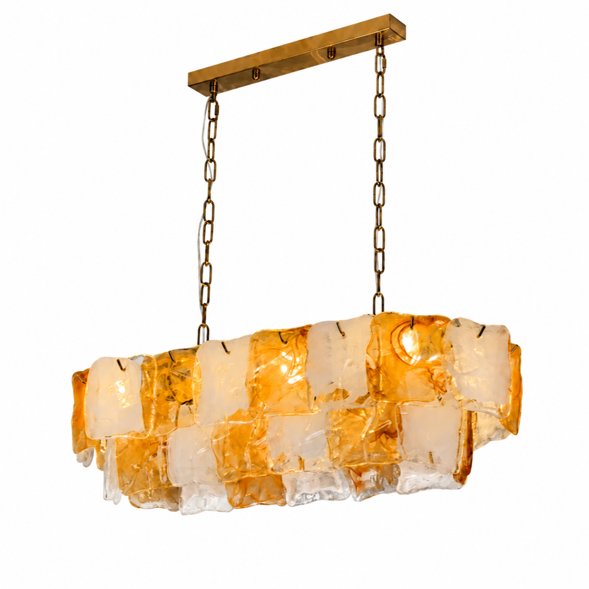 Linear chandelier with layered amber and frosted glass panels hangs from gold-toned chains against a white background.
