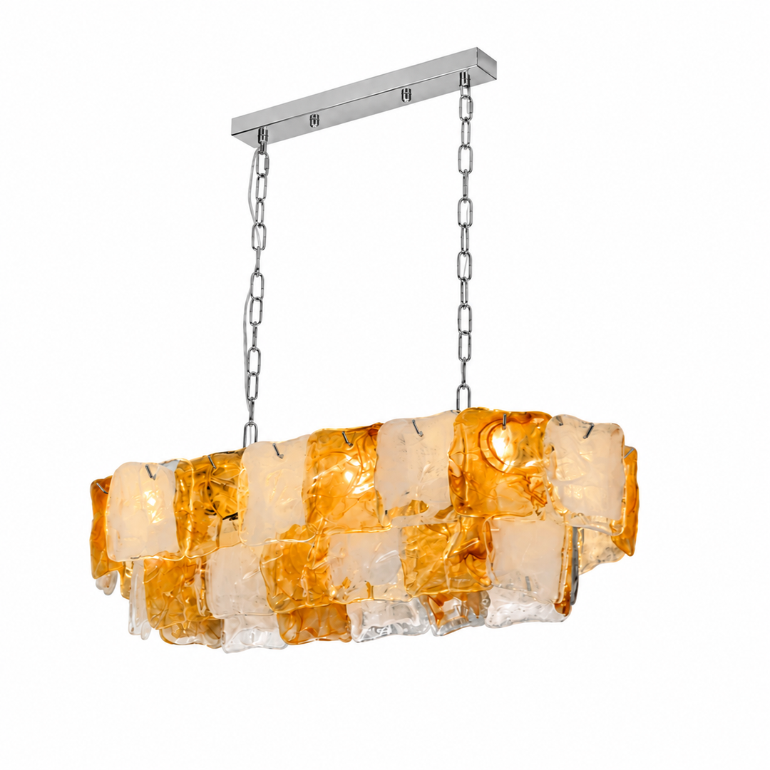 Linear chandelier with amber and frosted glass panels hangs from silver-toned chains and a matching canopy against a white background.