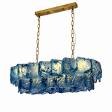 Linear chandelier with layered blue marbled art glass panels hanging from gold chains and a gold rectangular canopy on a white background.