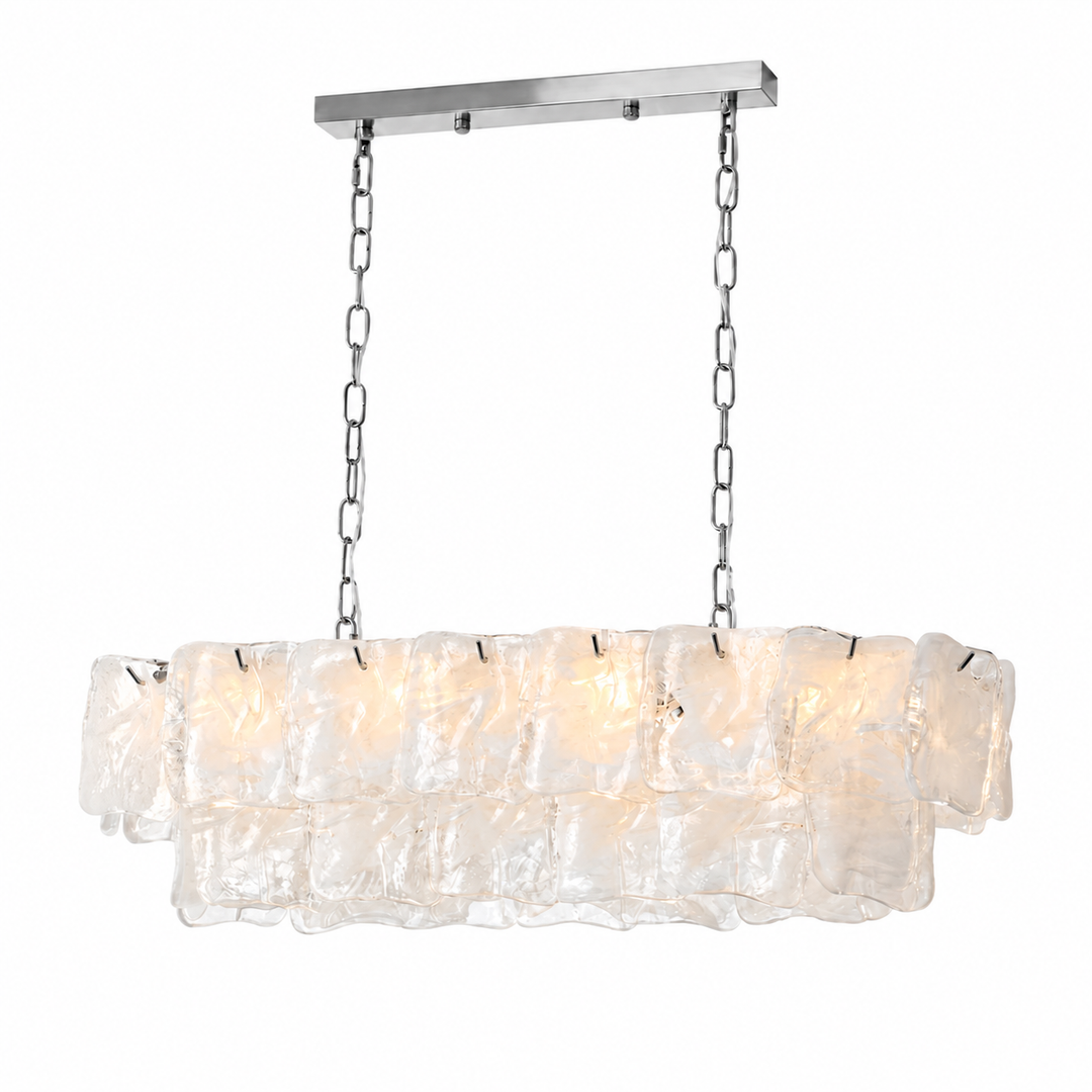 Linear chandelier with two tiers of frosted clear art glass panels suspended by chrome chains from a silver rectangular canopy.