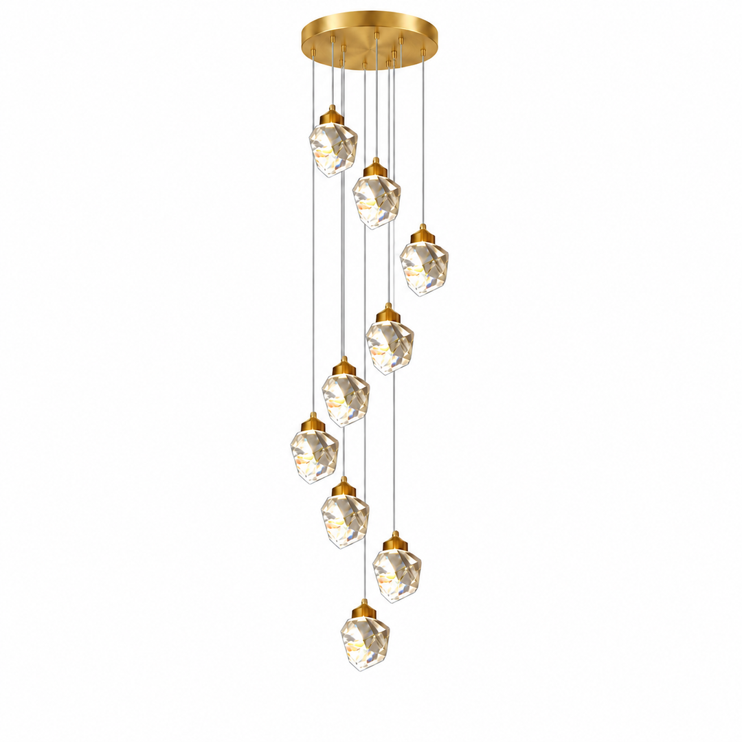 A modern multi-light linear chandelier with a brushed gold circular ceiling canopy, gold-finished caps, and faceted clear glass pendant globes suspended on thin cords against a plain white background.