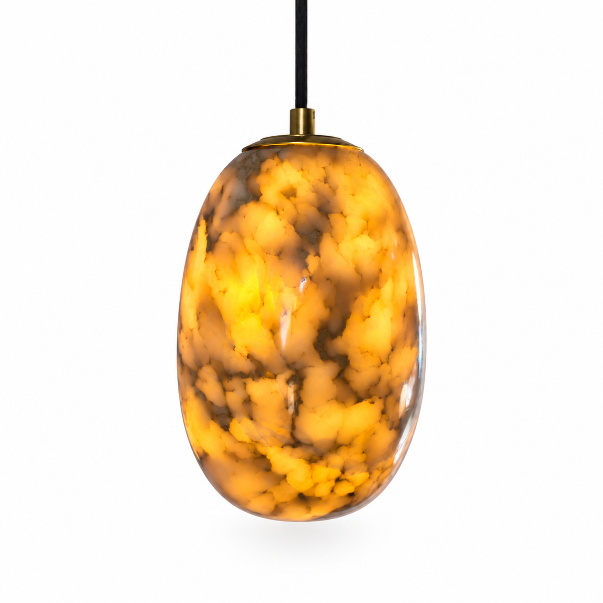 An oval pendant light with a glossy, marbled amber and gold glass shade, suspended by a black cord with a brass top cap, set against a plain white background.