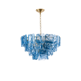A modern tiered chandelier featuring textured blue glass panels suspended from a gold-toned chain and ceiling canopy, shown against a plain white background.