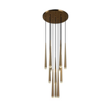 A modern multi-light linear chandelier with a circular brushed brass canopy, multiple vertical black suspension rods, and tapered brass glass shades, shown against a plain white background.