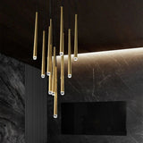 Modern chandelier with gold fixtures on a dark wall