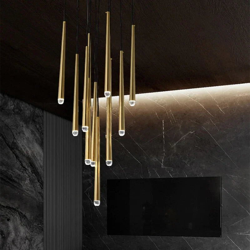 Modern chandelier with gold fixtures on a dark wall