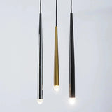 Three tapered chandelier tubes in silver, gold, and black finishes hang against a pale gray background with illuminated crystal tips.