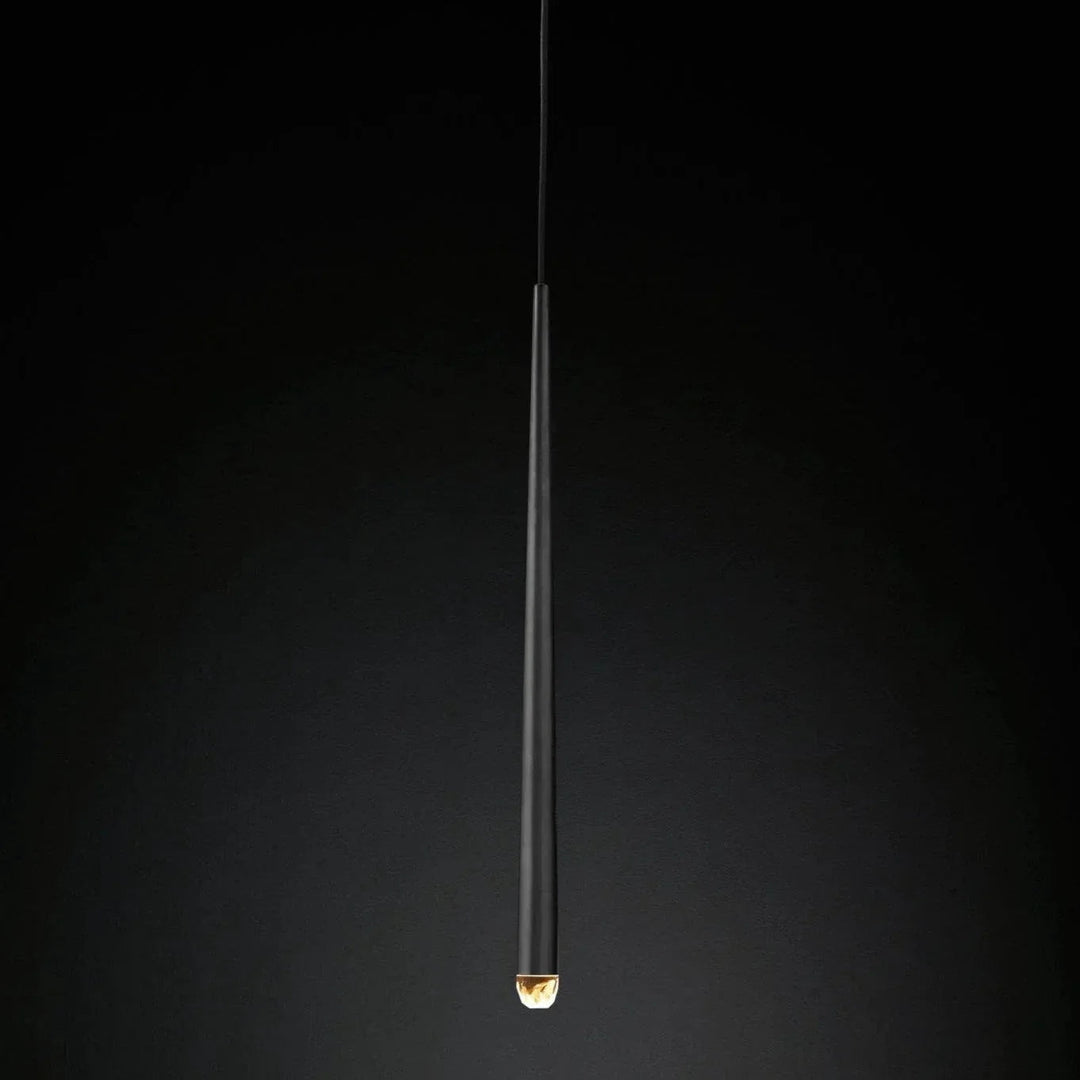 Chandelier detail showing a slender black tapered tube with an illuminated crystal tip against a dark gradient background.