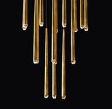 Gold cylindrical chandelier against a black background