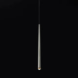 Chandelier detail showing a reflective silver tapered tube with a glowing crystal tip suspended against a black background.