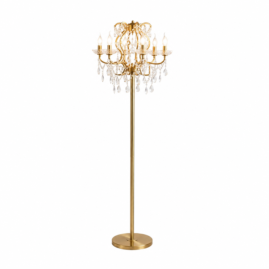 A gold floor lamp with a multi-arm chandelier-style top, clear hanging crystal prisms, and a round base, shown on a plain white background.