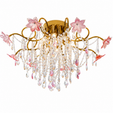 Gold-tone chandelier with curling arms, pink flowers, and cascading clear and pink teardrop pendants against a white background.