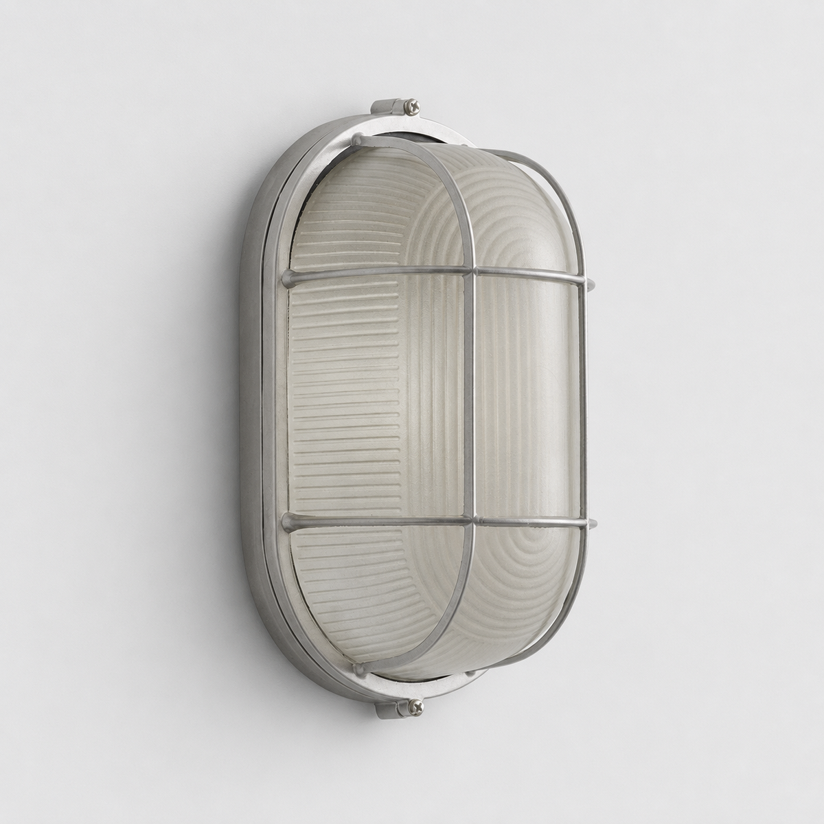 An oval wall sconce with a silver cage frame and ribbed frosted glass is mounted vertically on a light gray wall.