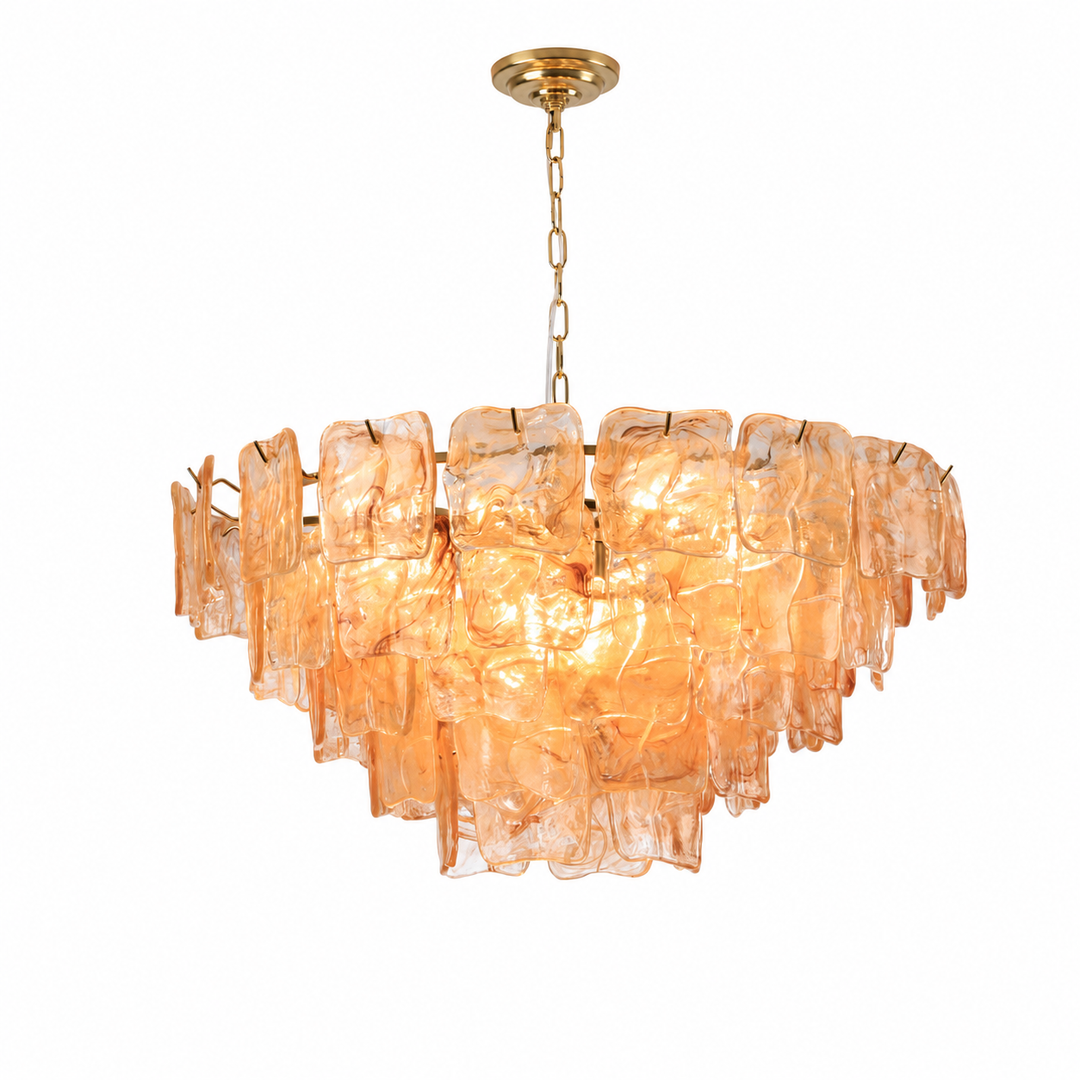 A modern tiered chandelier featuring textured, translucent amber-orange glass panels suspended from a gold-finished metal frame and chain.