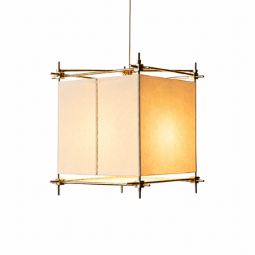 An illuminated hanging lamp has cream fabric panels and a gold-toned geometric frame against a white background.