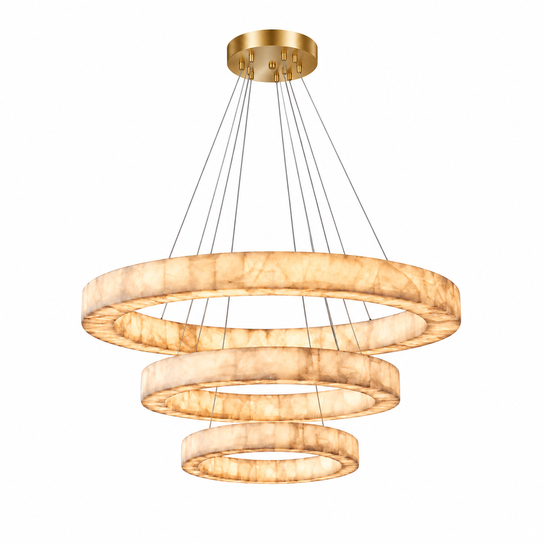 Three-tier alabaster ring chandelier glows warm cream beneath a brushed gold canopy against a white background.